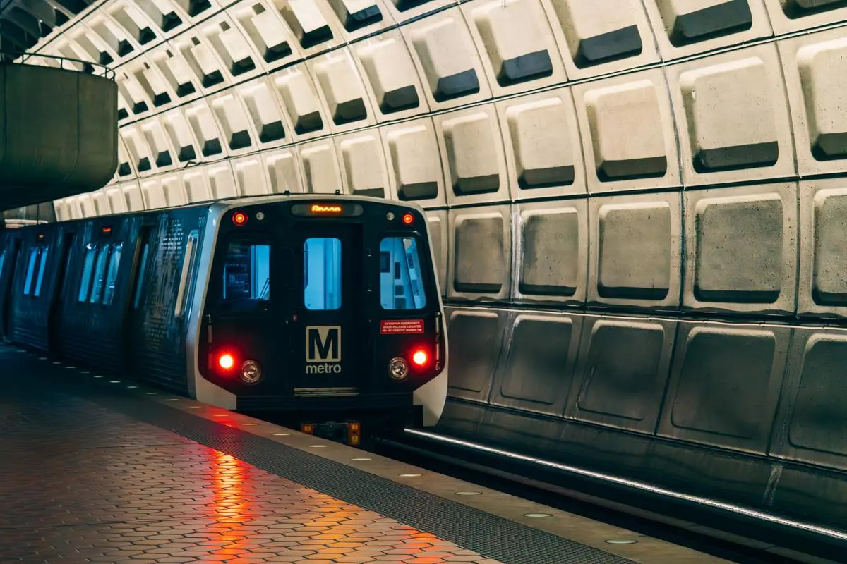 Washington Metro train entering an underground station featuring iconic Brutalist architecture in Washington, D.C.
